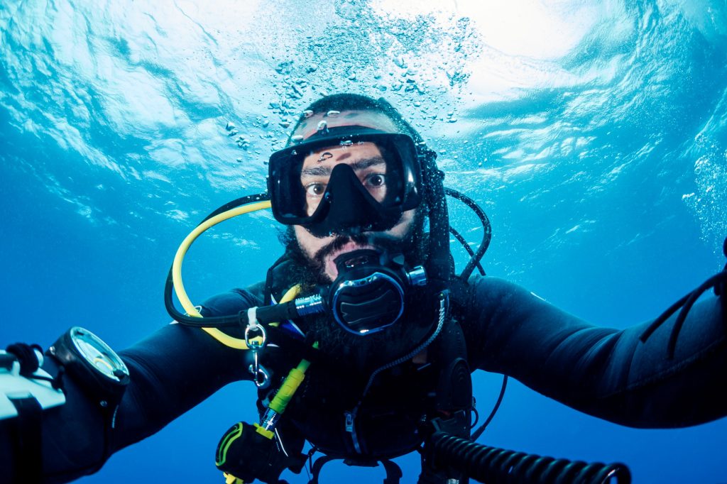 selfie portrait of a male scuba diver in wetsuit